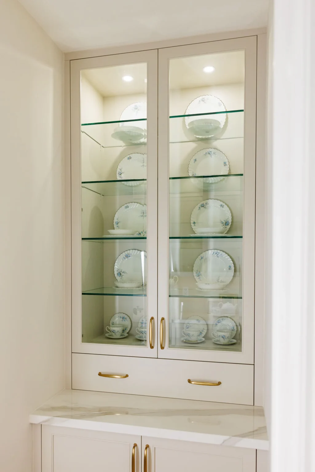Lit china cabinet with glass doors and shelves