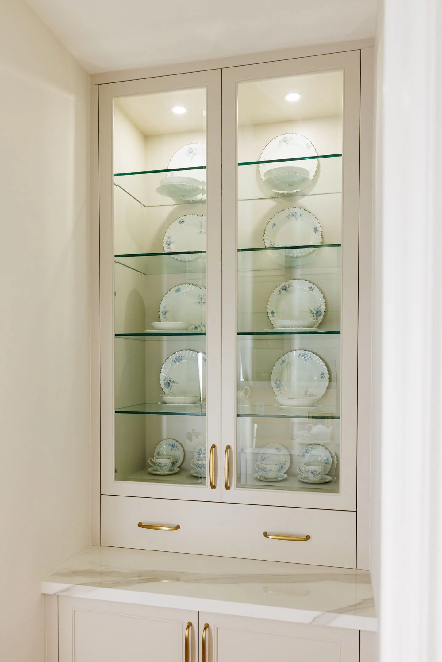 Lit china cabinet with glass doors and shelves
