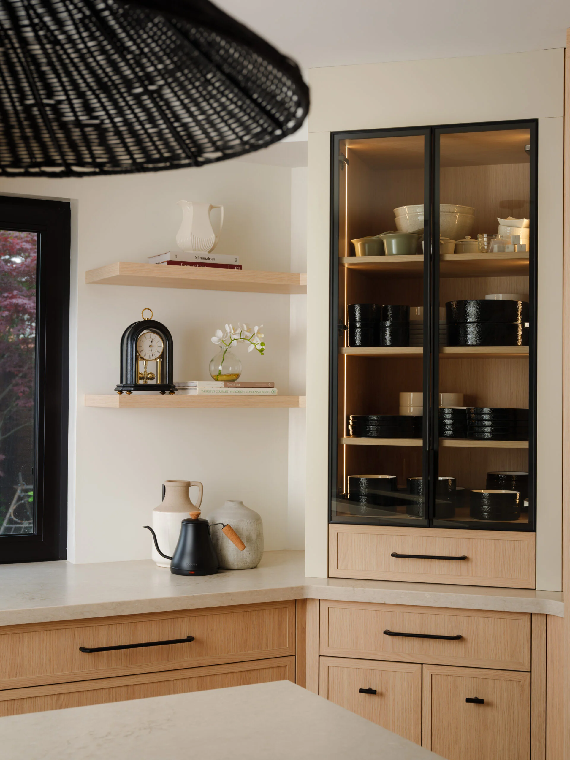 Glass-front display cabinet and open shelving in an Oakville custom kitchen
