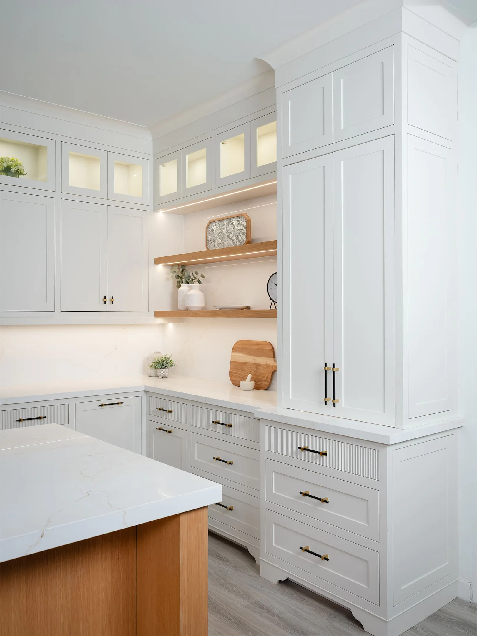 Painted framed inset cabinetry with glass-front upper cabinets and open shelving