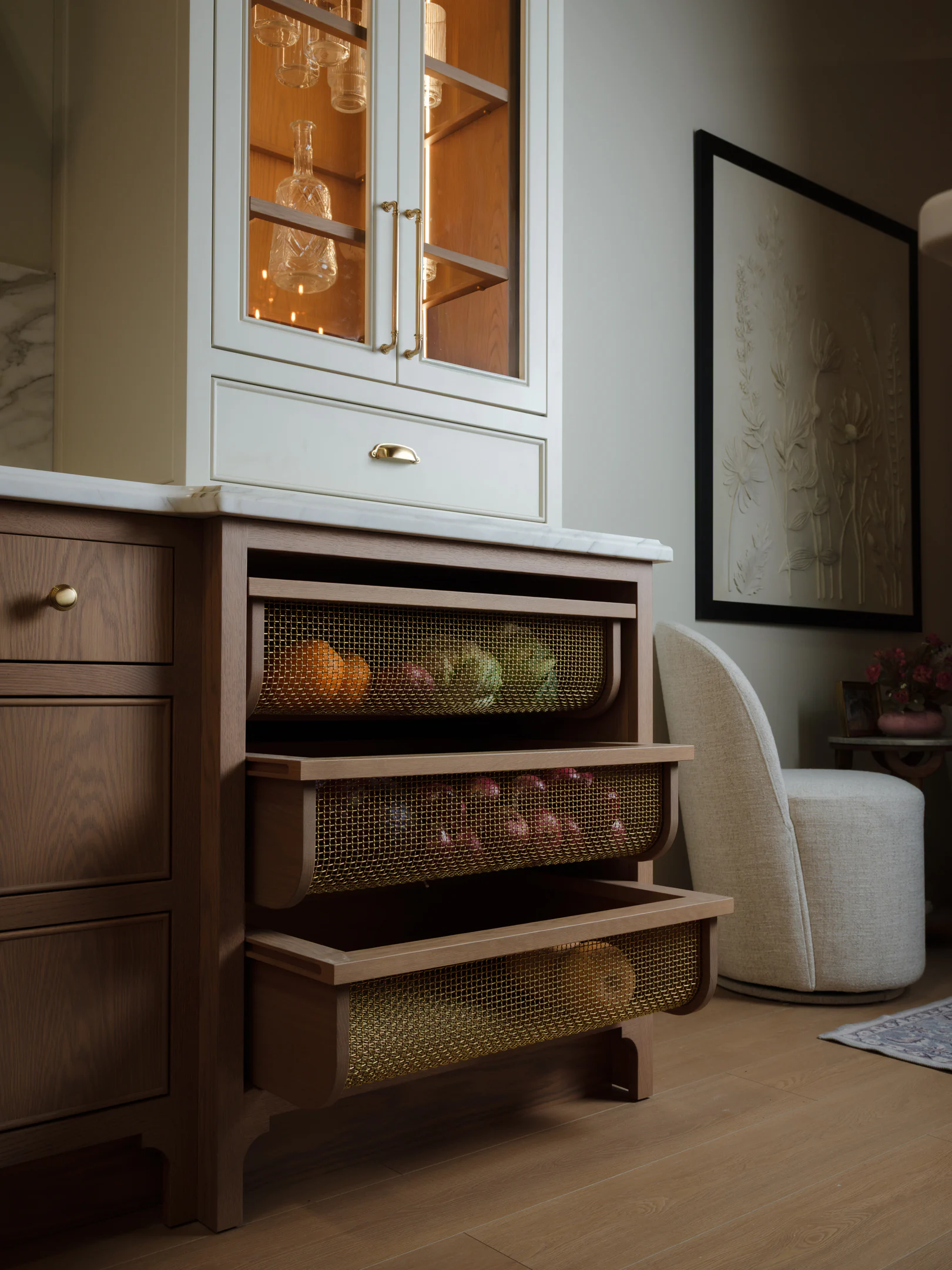 Produce drawers with brass detailing in white oak cabinetry