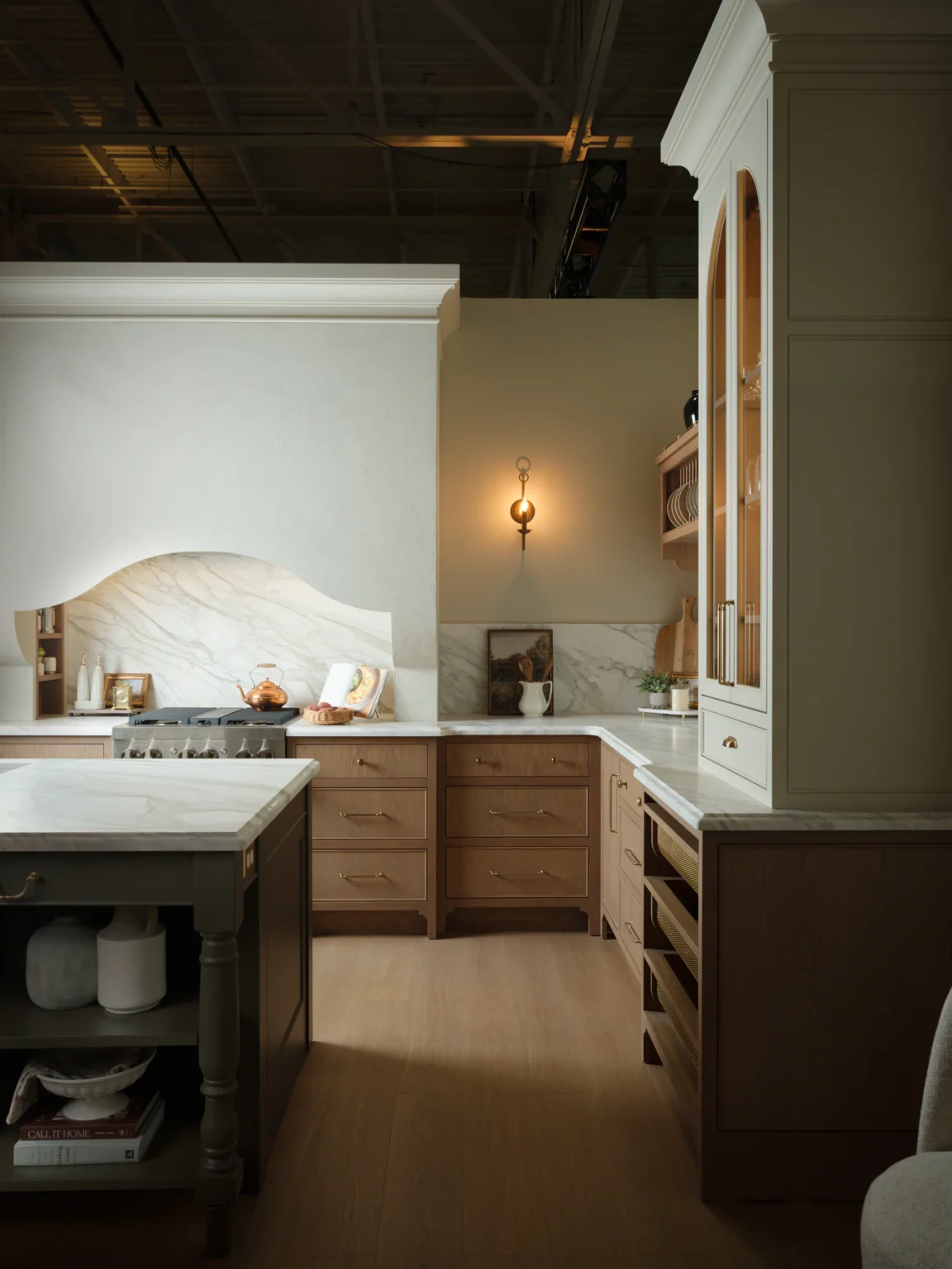 White oak framed inset cabinetry, a painted island and an arched hutch at the AWDS showroom in Caledon