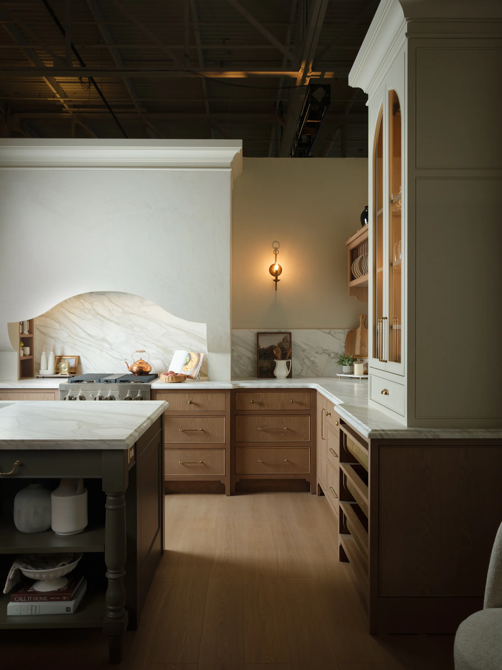 White oak framed inset cabinetry, a painted island and an arched hutch at the AWDS showroom in Caledon